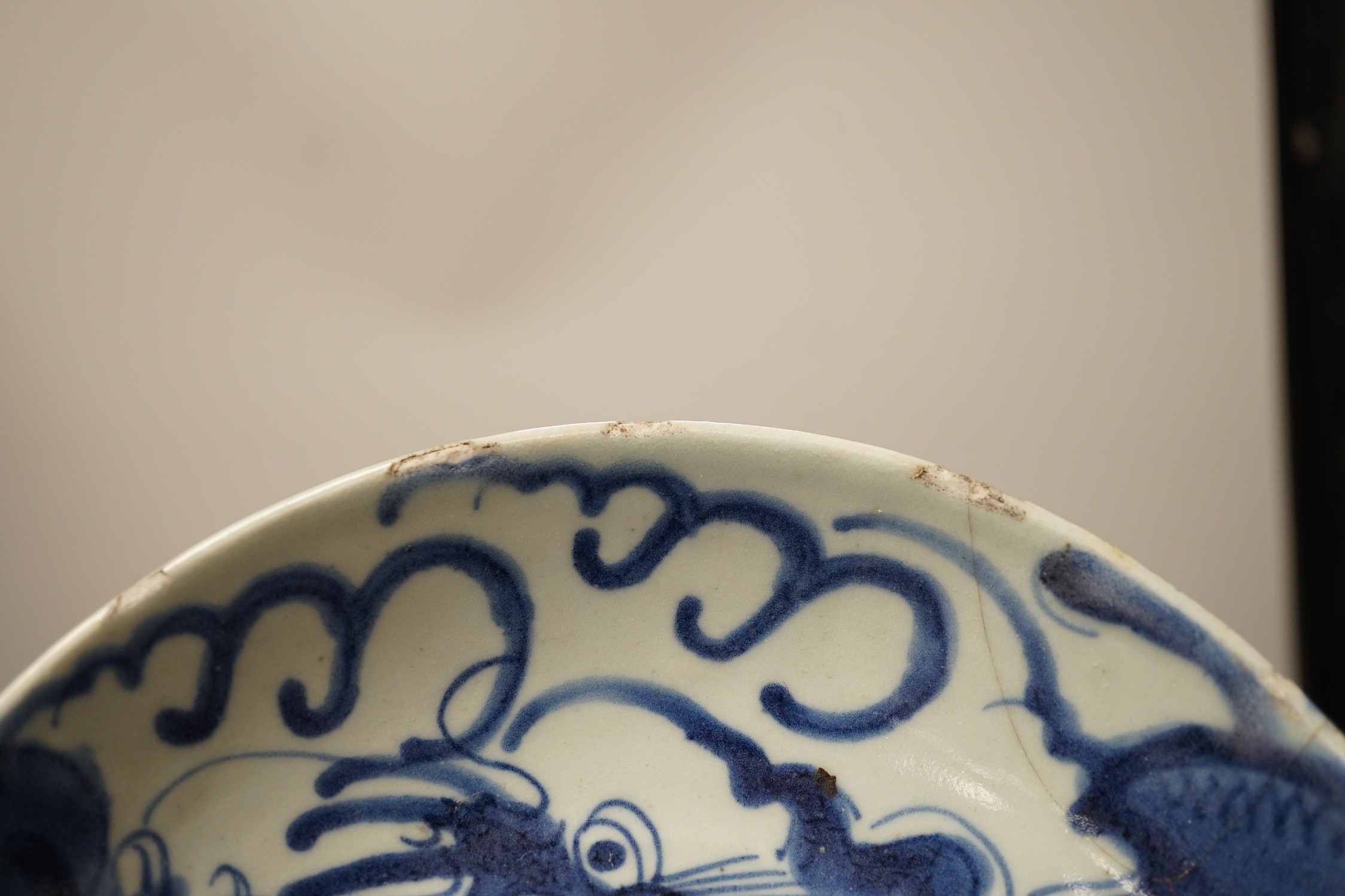 Two 19th century Chinese blue and white dishes and two 18th century tea bowls, largest 23cm diameter